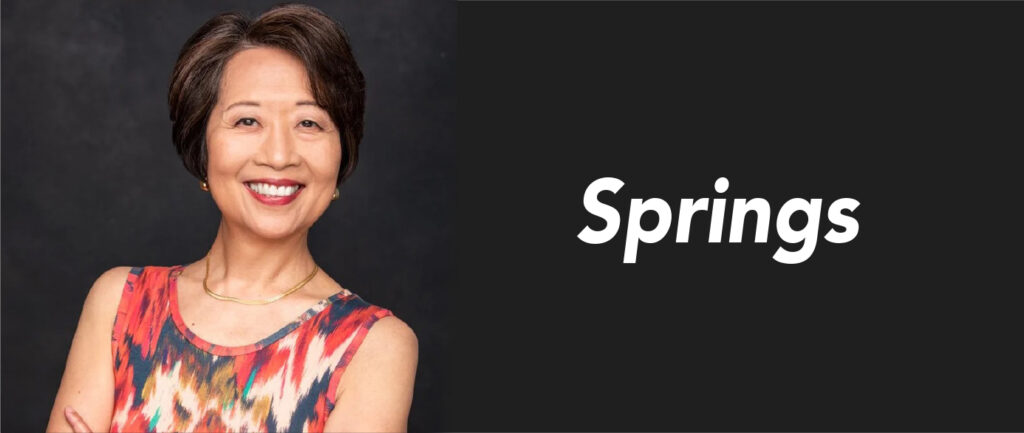 An Asian woman in a floral dress smiles for the camera. Next to her is the word "Springs."